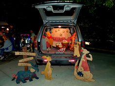 winnie the pooh and friends are sitting in the trunk of a car at night