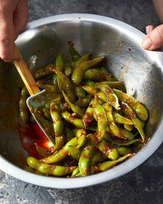 a person is stirring some food in a bowl