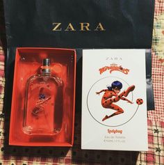 a bottle of perfume sitting next to a box