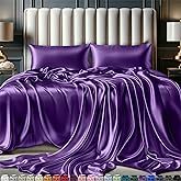 a bed covered in purple sheets and pillows