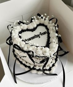 a heart shaped cake in a white box