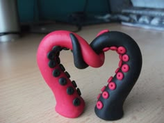 two black and red objects on a wooden table