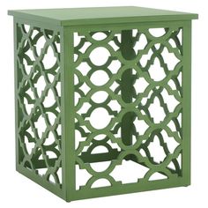 a green side table with an intricate design