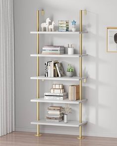 a white and gold book shelf with books on it