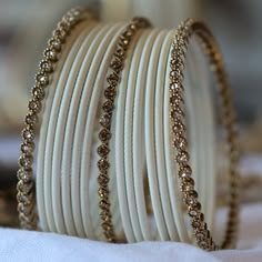 A stylish and versatile way to accessories your wrists is with our Radiant Bangle Set. Curated using our stunning antique gold crystal and white matte bangles. Complement with your outfits or wear alone to add a touch of glamour to your look. ABOUT THIS PRODUCT 15 bangles in total antique gold finish light topaz crystals matte bangles sizes available Indian Aesthetic Earrings, Elegant Bangles, White Gold Bangles, Wedding Bangles, White Bangles, White Bangles Set, Bangle Aesthetic