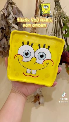 a person holding up a yellow spongebob square plate with the words thank you india for order