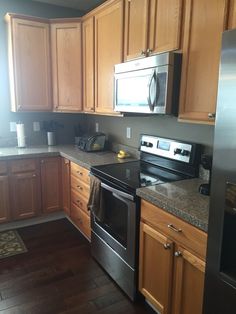 a kitchen with stainless steel appliances and wooden cabinets