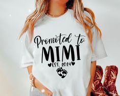 a woman wearing a white t - shirt with the words, premmed to mimi west