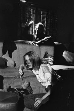 black and white photograph of a woman sitting on a couch