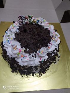 a birthday cake with white frosting and sprinkles