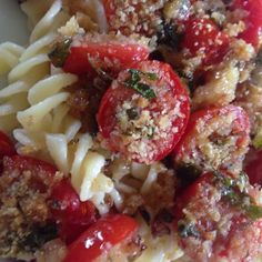 pasta with meat, tomatoes and sauce in a white bowl