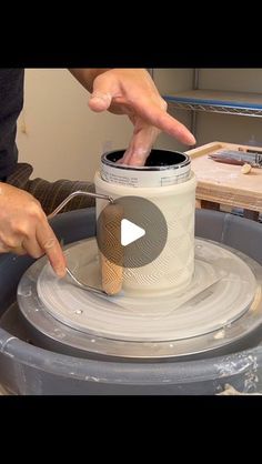 a man is making a vase out of clay