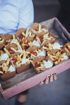 a tray filled with lots of tasty looking food on top of a wooden table