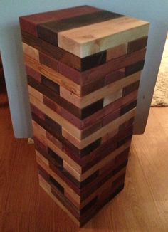 a large wooden block sitting on top of a hard wood floor next to a wall