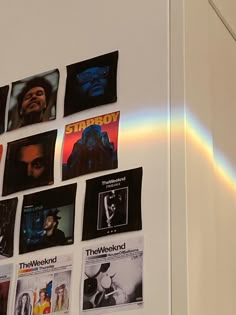 a white wall with pictures and rainbow in the backgroung, on it