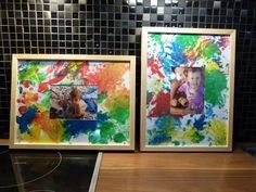 two frames with different colored paint on them next to a stove top oven in a kitchen