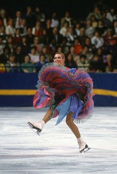 a female figure skating on an ice rink