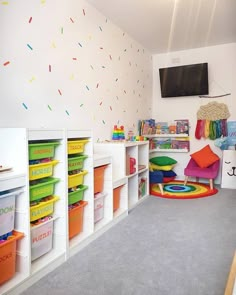 a child's playroom with toys and storage bins