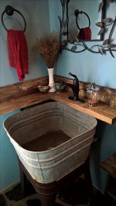 an old fashioned sink in a bathroom with blue walls and wood accents on the wall