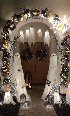 an archway decorated with halloween decorations and lights