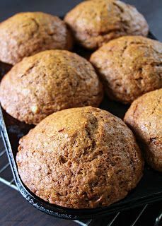 several muffins are cooling on a rack