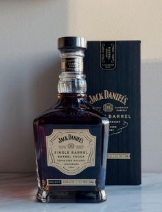 a bottle of jack daniels single barrel whiskey sitting on a counter next to a box