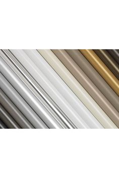 several different types of metal pipes in various colors and sizes, all lined up together