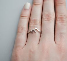 This sterling silver mountain ring looks great on its own or in a stack. Pair it with birthstone rings and you have a stylish way to keep your loved ones close even when they're far away. Rings are only sold in sizes 5 6 7 8 9 10. ..........PRODUCT DETAILS•Ring is solid 925 sterling silver •Width of band measures 1mm •Mountain face height is 7.5mm•Comes beautifully packaged in a gift box..........SHIPPING and POLICIES• Orders are made and shipped within 3-5 business days. See listing photos for Minimalist Rings Simple, Silver Mountain Ring, Mountain Ring, Silver Mountain, Mountain Jewelry, Birthstone Rings, Equestrian Jewelry, Ring Tattoos, Nature Ring