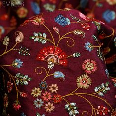 a close up view of a red flowered hat