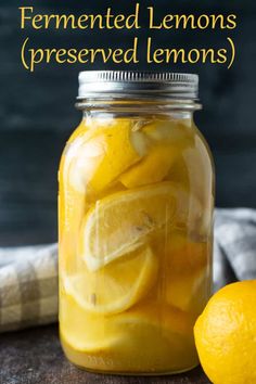 a mason jar filled with lemons and sliced lemons