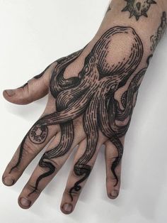 a hand with an octopus tattoo on it