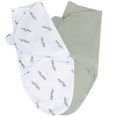 two baby swaddles with leaves on them, one is green and the other is white