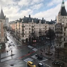 a city street filled with lots of traffic and tall buildings on both sides of it