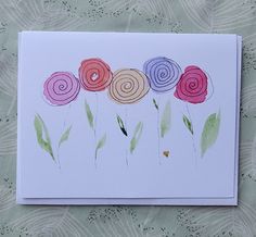 a card with flowers painted on it