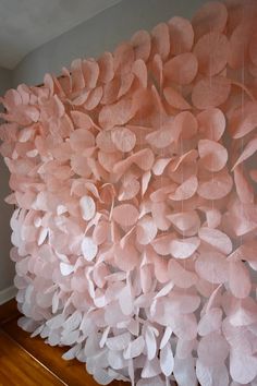 a pink wall hanging on the side of a wooden floor