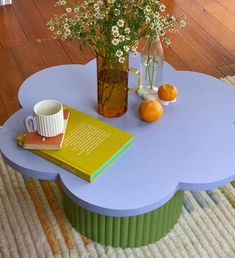 a coffee table with flowers and books on it