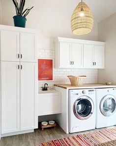 a washer and dryer sitting in a room next to each other on top of a rug