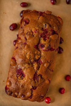 a loaf of cranberry bread sitting on top of a piece of parchment paper