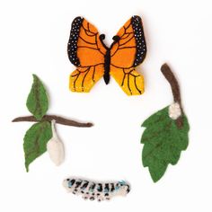 felt butterflies and caterpillars on white background