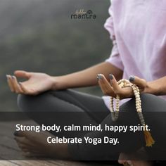 a woman is sitting on the ground with her hands clasped in yoga poses and holding beads