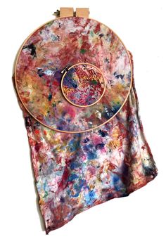 an artistically painted purse with a wooden frame on it's back and handles