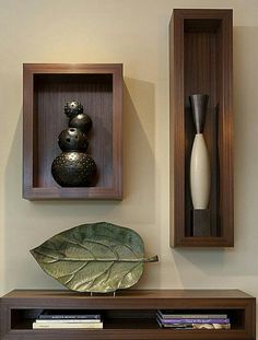 two wooden shelves with vases and other decorative items on them, along with a book shelf