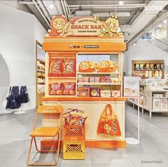 an orange snack bar in a store filled with lots of food and snacks on display