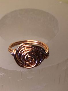 Copper wire wrapped swirl ring. Gift for her. I handmade this ring with pure round copper wire.  I've included a care card to clean your ring and keep it shiny.  Great  Mother's Day gift! It is said to have benefits when wearing Copper jewelry: Healthy Immune System. Copper improves physiological balance and strengthens the body Revitalises the Heart Maintains Blood Pressure Improves Cardiovascular Health Strengthens the Bones Promotes Absorption of Minerals Improves Skin Health Reduces Swelling Rose Rings, Copper Wire Ring, Wire Wrap Ring, Wrapped Rings, Ring Wire, Crystal Choker Necklace, Swirl Ring, Wire Ring, Simple Ring