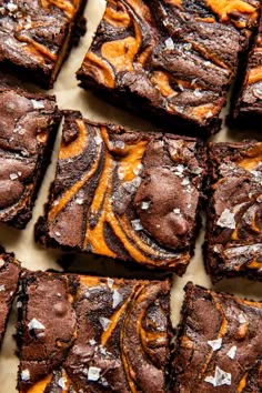 chocolate brownies with orange swirl frosting and white sprinkles on top