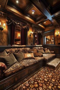 a living room filled with lots of couches and pillows on top of a rug