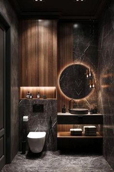 a modern bathroom with marble walls and flooring, including a round mirror above the sink