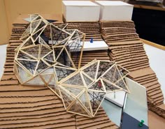 an architectural model sits on top of cardboard