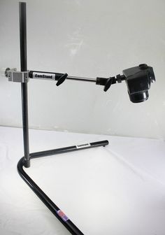 a camera mounted on top of a tripod with a microphone attached to the arm