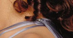 the back of a woman's head wearing a tie